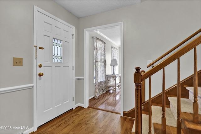 entrance foyer featuring hardwood / wood-style floors and a textured ceiling