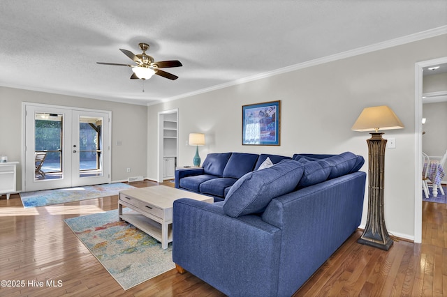 living room with dark hardwood / wood-style flooring, crown molding, french doors, and a textured ceiling