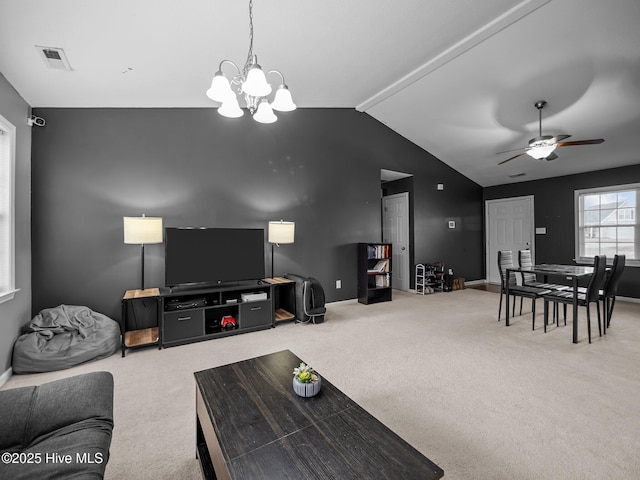 carpeted living room with ceiling fan with notable chandelier and vaulted ceiling with beams