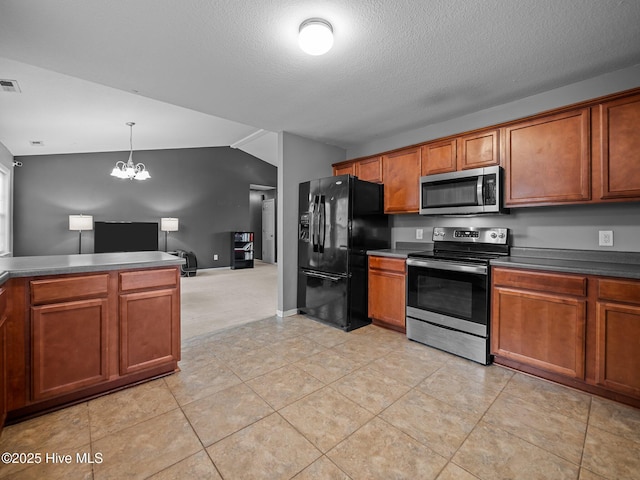 kitchen with pendant lighting, stainless steel appliances, a textured ceiling, vaulted ceiling, and a chandelier