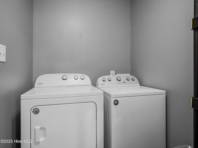 clothes washing area featuring separate washer and dryer