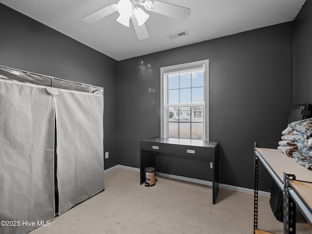 misc room featuring ceiling fan and light carpet