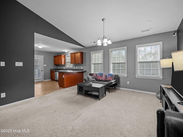 carpeted living room with an inviting chandelier, sink, and vaulted ceiling