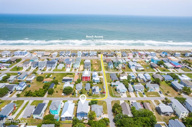 birds eye view of property with a view of the beach and a water view