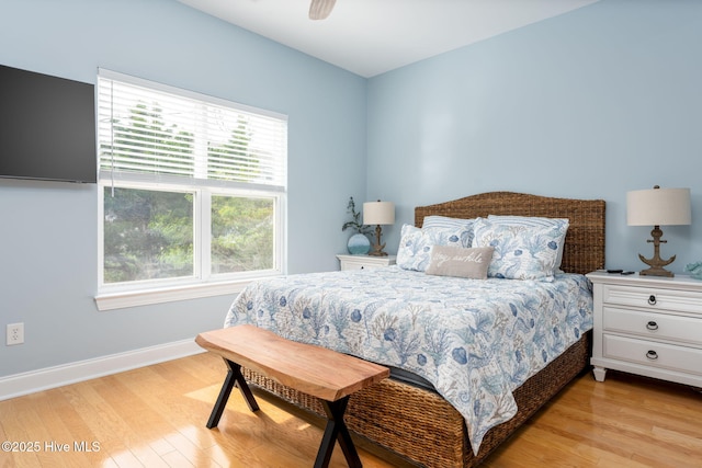 bedroom with ceiling fan and light hardwood / wood-style flooring