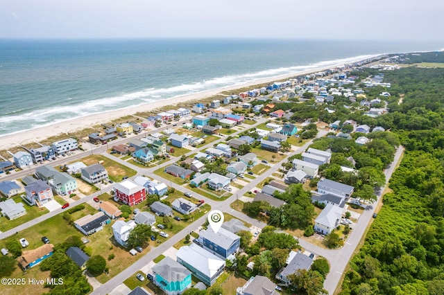 drone / aerial view featuring a water view and a beach view