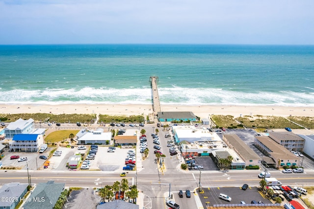 birds eye view of property with a beach view and a water view