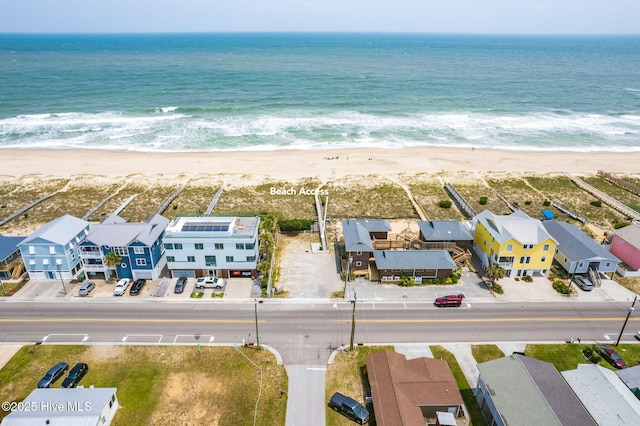 bird's eye view featuring a water view and a view of the beach