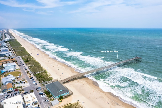 birds eye view of property with a water view and a beach view