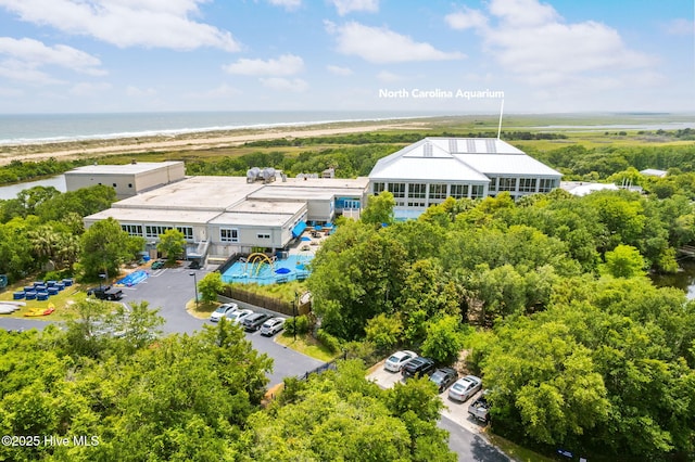 bird's eye view featuring a water view and a view of the beach