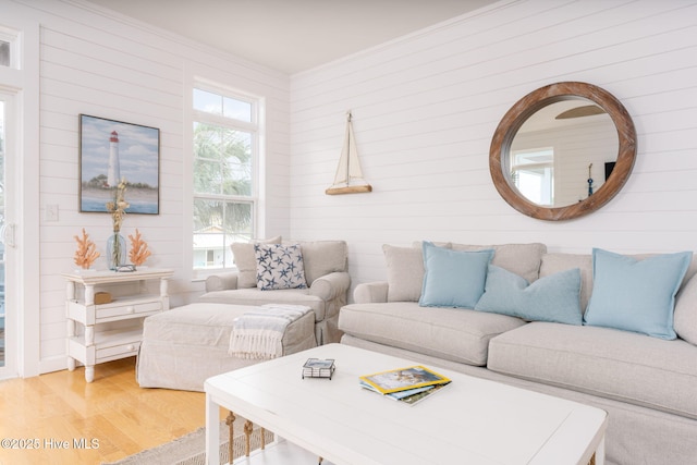 living room featuring wood-type flooring and ornamental molding