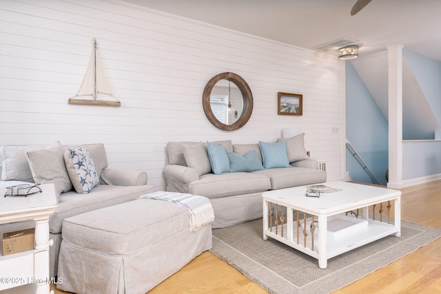 living room featuring wood-type flooring and vaulted ceiling