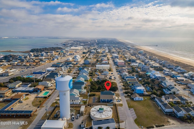 birds eye view of property featuring a beach view and a water view