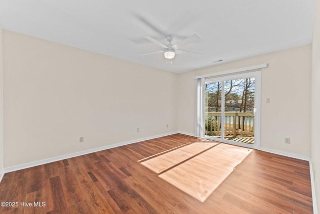 empty room featuring hardwood / wood-style floors and ceiling fan