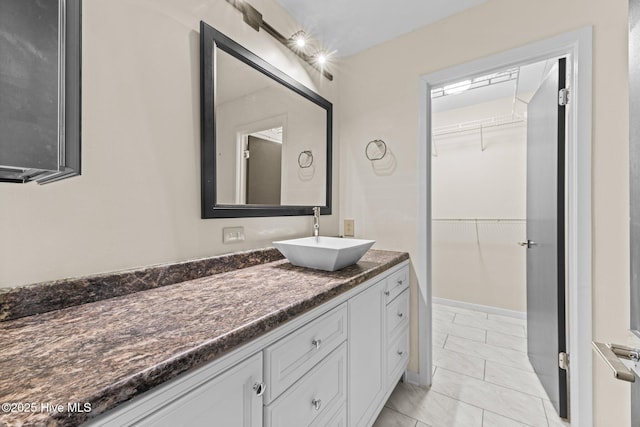 bathroom featuring tile patterned flooring and vanity