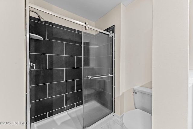 bathroom with walk in shower and toilet