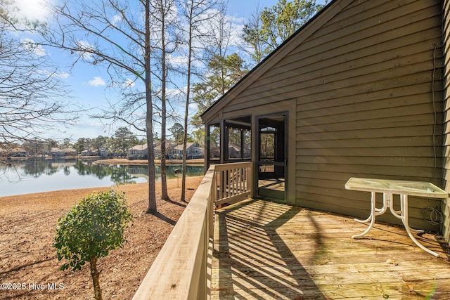 wooden terrace featuring a water view