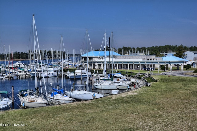 view of dock featuring a water view and a lawn