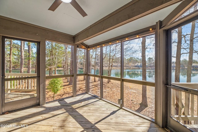 unfurnished sunroom with a water view and ceiling fan