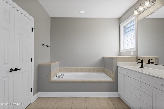 bathroom with tile patterned flooring, vanity, and a bathtub