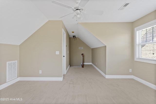 additional living space featuring lofted ceiling, light colored carpet, and ceiling fan