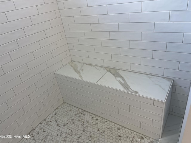 bathroom with tiled shower