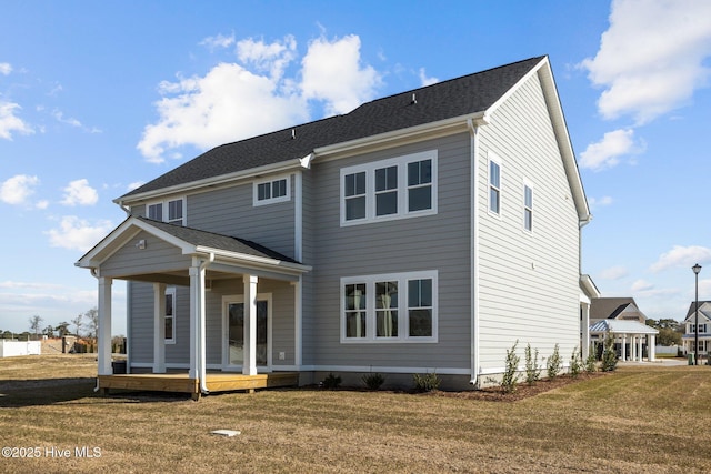 back of house with a yard and covered porch