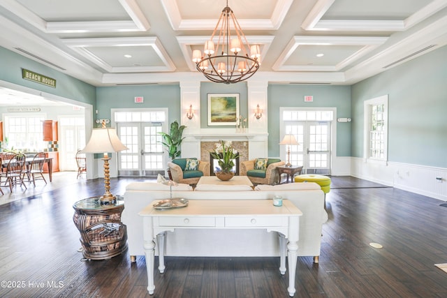 living room with dark hardwood / wood-style floors, a wealth of natural light, and french doors