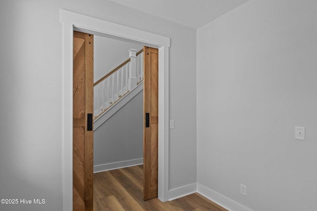 hall featuring baseboards and wood finished floors