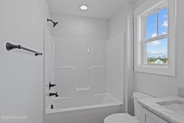 bathroom featuring toilet,  shower combination, and vanity