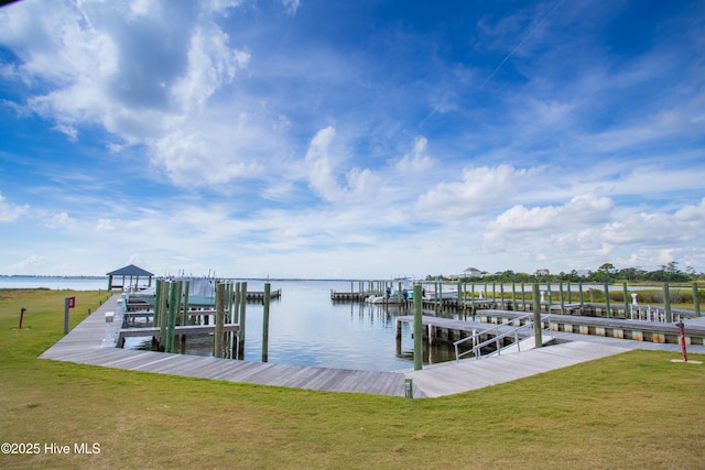 view of dock featuring a yard, a water view, and boat lift