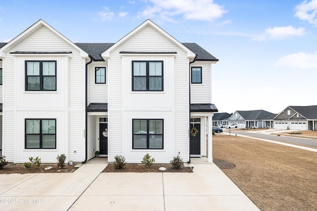 view of property featuring a front lawn