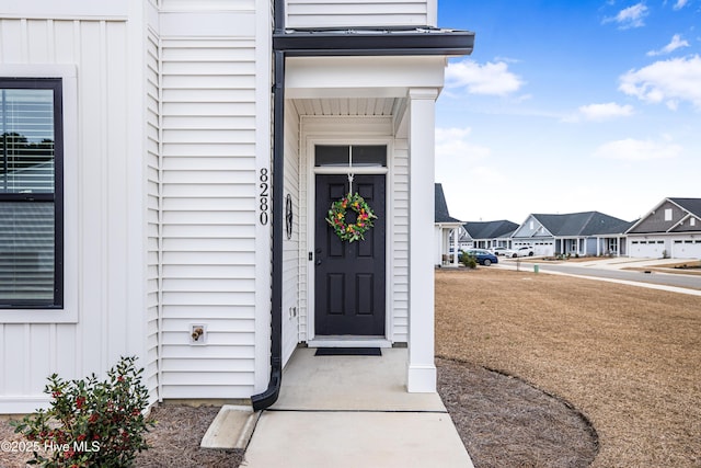 doorway to property featuring a yard