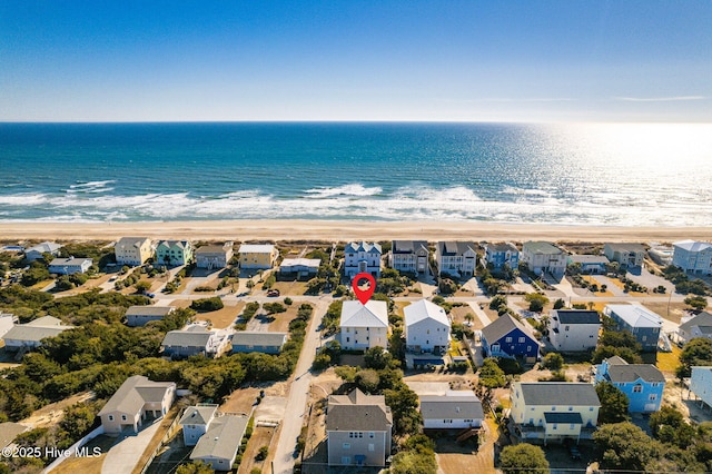 bird's eye view with a water view and a beach view