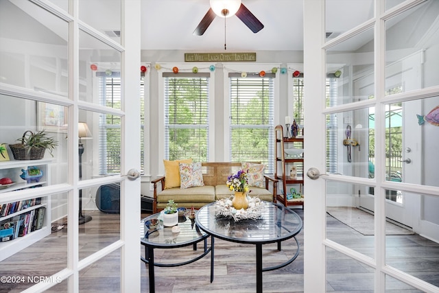 sunroom / solarium with ceiling fan, french doors, and visible vents