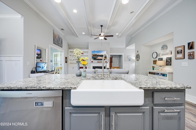 kitchen featuring ornamental molding, open floor plan, a sink, gray cabinets, and stainless steel dishwasher