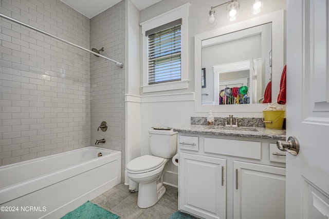 full bath featuring wainscoting, toilet, tile patterned flooring, vanity, and shower / bathing tub combination