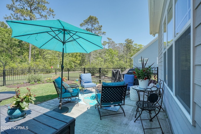 view of patio with an outdoor hangout area and fence