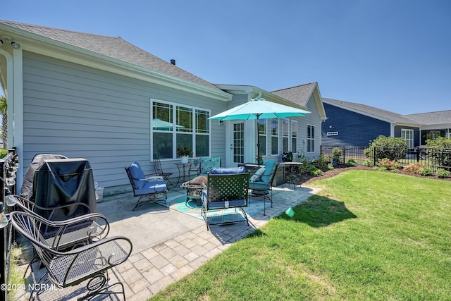 back of property featuring a fire pit, a patio, a yard, and fence