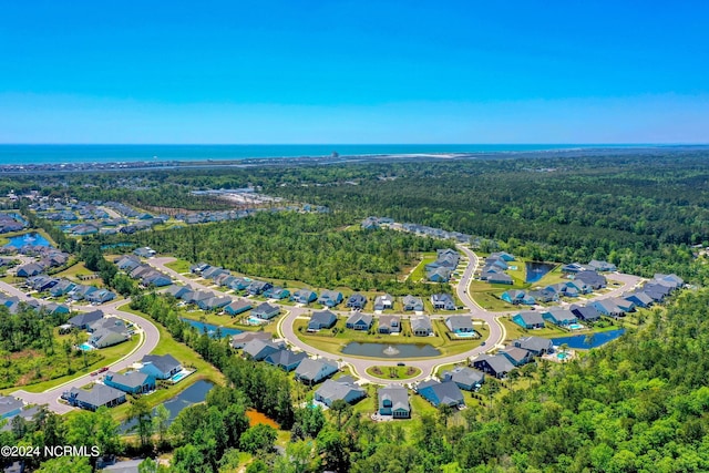 aerial view featuring a residential view, a water view, and a forest view