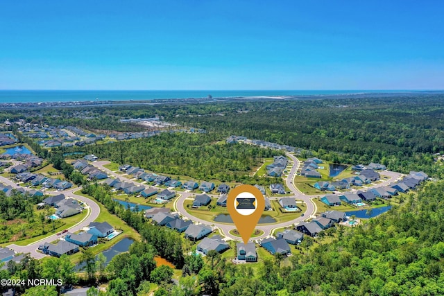 bird's eye view with a residential view, a water view, and a forest view