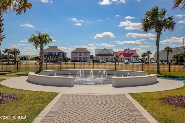 view of property's community with fence and a yard