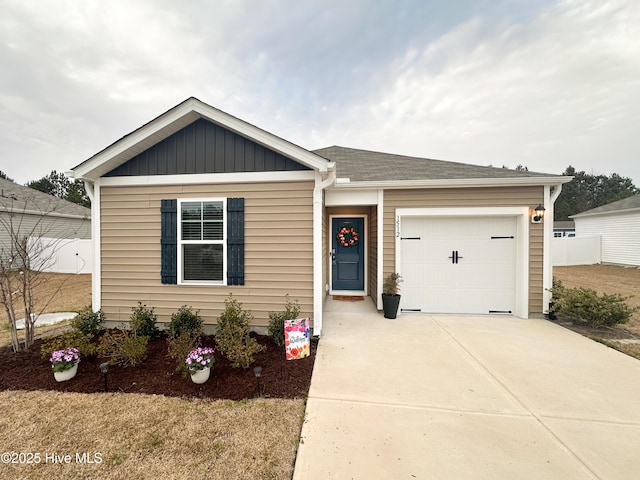 view of front of property with concrete driveway, board and batten siding, and an attached garage