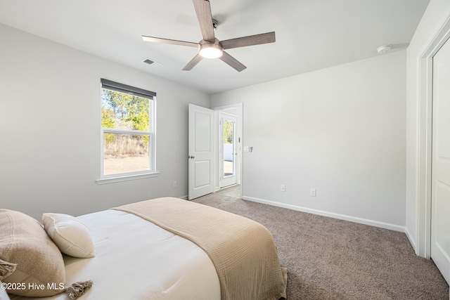 bedroom with ceiling fan and light carpet