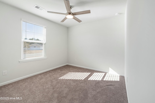 spare room featuring a ceiling fan, baseboards, visible vents, and carpet flooring