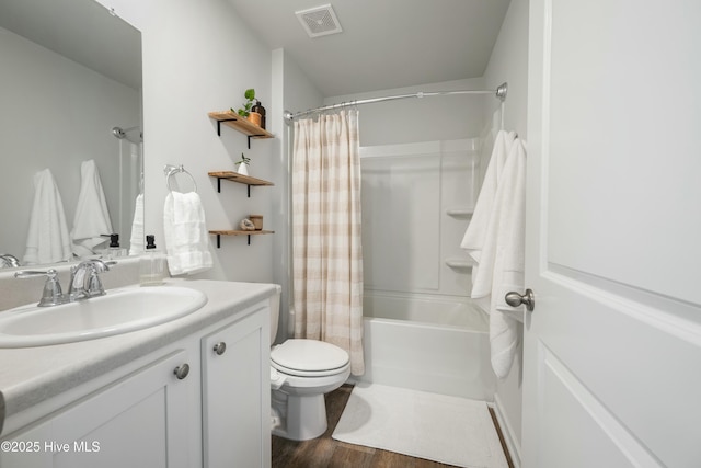 bathroom with shower / tub combo with curtain, visible vents, toilet, vanity, and wood finished floors