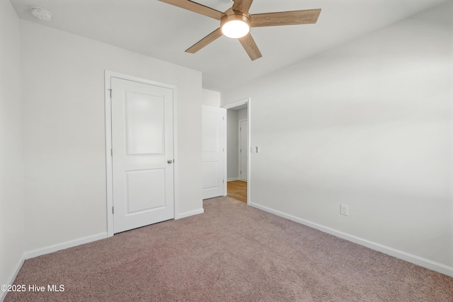 unfurnished bedroom featuring carpet floors, ceiling fan, and baseboards