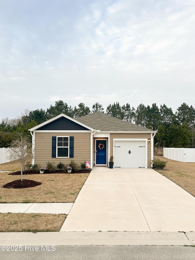 ranch-style home featuring driveway, a garage, fence, a front lawn, and board and batten siding