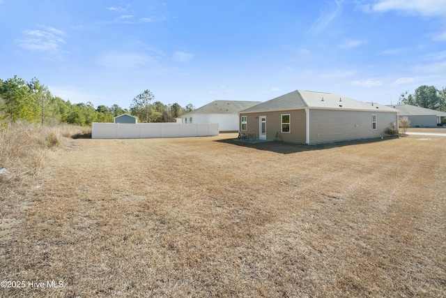 back of house featuring fence