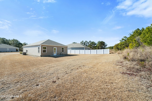 back of property with fence and a patio